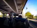 View from a coach seat through the window onto the road, a stand-in for the airport coach