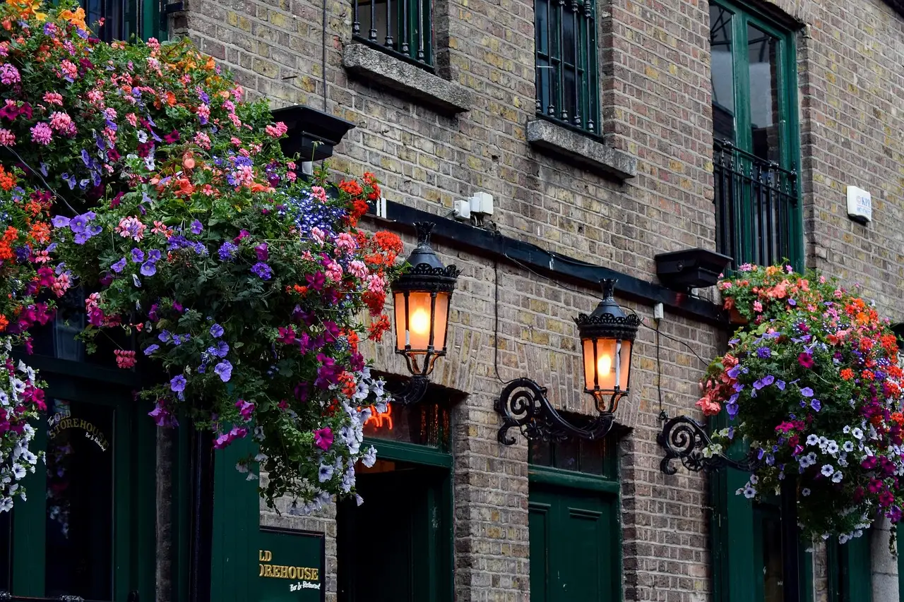 The front of a Dublin pub with hanging flower baskets and lanterns