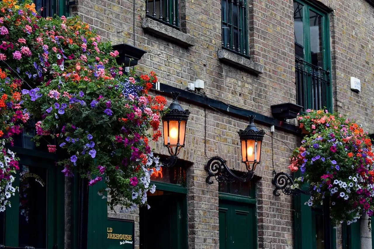 The front of a Dublin pub with hanging flower baskets and lanterns