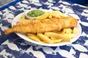 Battered fish with chips and mushy peas on a plate, a classic Irish pub dish (generic food photo, not a named restaurant)