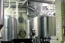 Steel brewing tanks and pipes in a small brewery