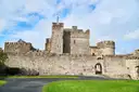 Cahir Castle, with its stone keep and walls behind a lawn