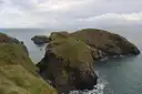 The Carrick-a-Rede rope bridge linking the cliffs to a small green island above the sea