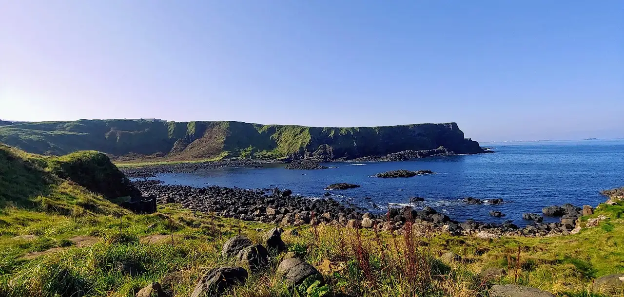 A rocky bay on the Causeway Coast with green headlands