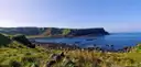A rocky bay on the Causeway Coast with green headlands