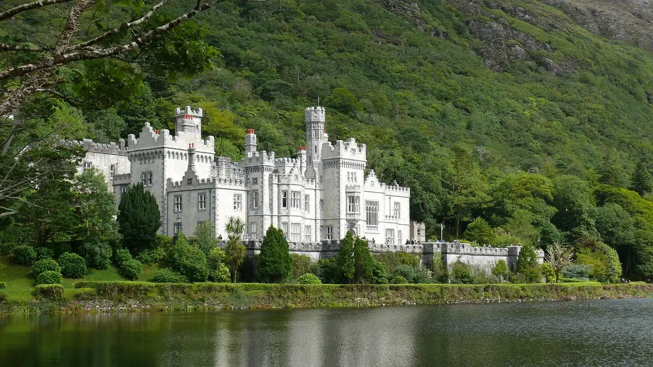 Kylemore Abbey on a lake in Connemara, County Galway (the region the bus leaves from; no photo of the coach itself)