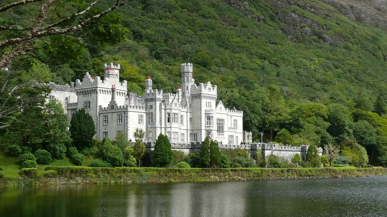 Kylemore Abbey on a lake in Connemara, County Galway (the region the bus leaves from; no photo of the coach itself)