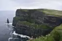 Green-topped cliffs and a tall sea stack at the Cliffs of Moher