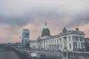 The Custom House on the River Liffey in Dublin, with its green dome under a cloudy sky