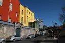 Old stone walls and painted houses of Dublin Castle seen from the street outside