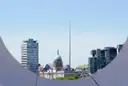 Dublin's skyline seen through the curve of a bridge, with the Spire and the Custom House dome