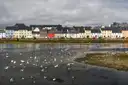 A row of colourful houses along the water in Galway city