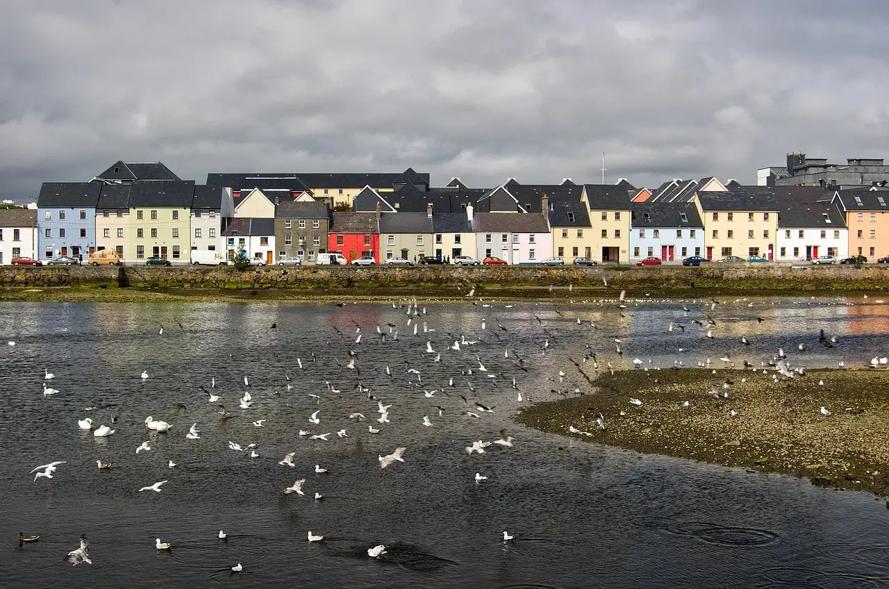 A row of colourful houses along the water in Galway city