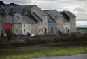A row of coloured houses on the Long Walk by the water in Galway