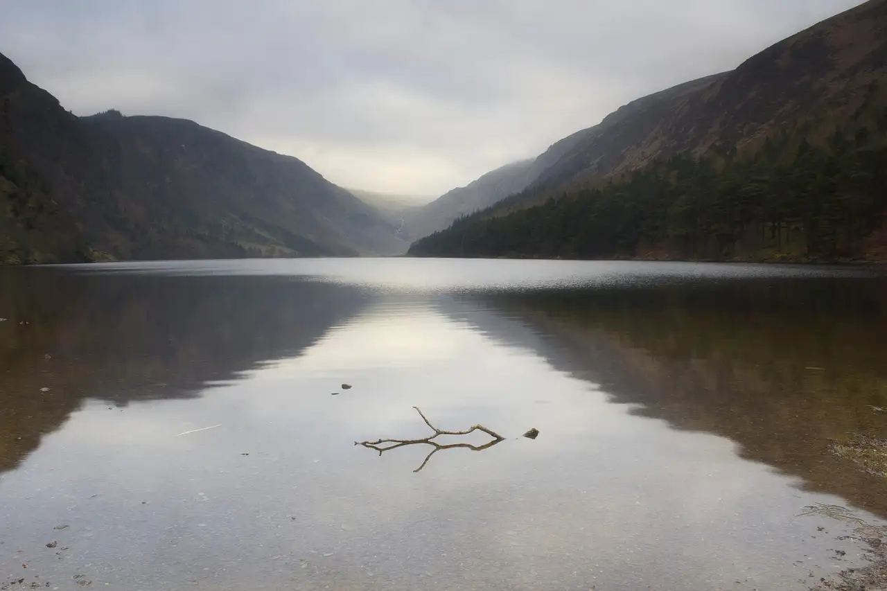 The Upper Lake at Glendalough between steep, misty valley sides