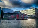 The Grand Canal Dock in Dublin with modern buildings and red poles by the water