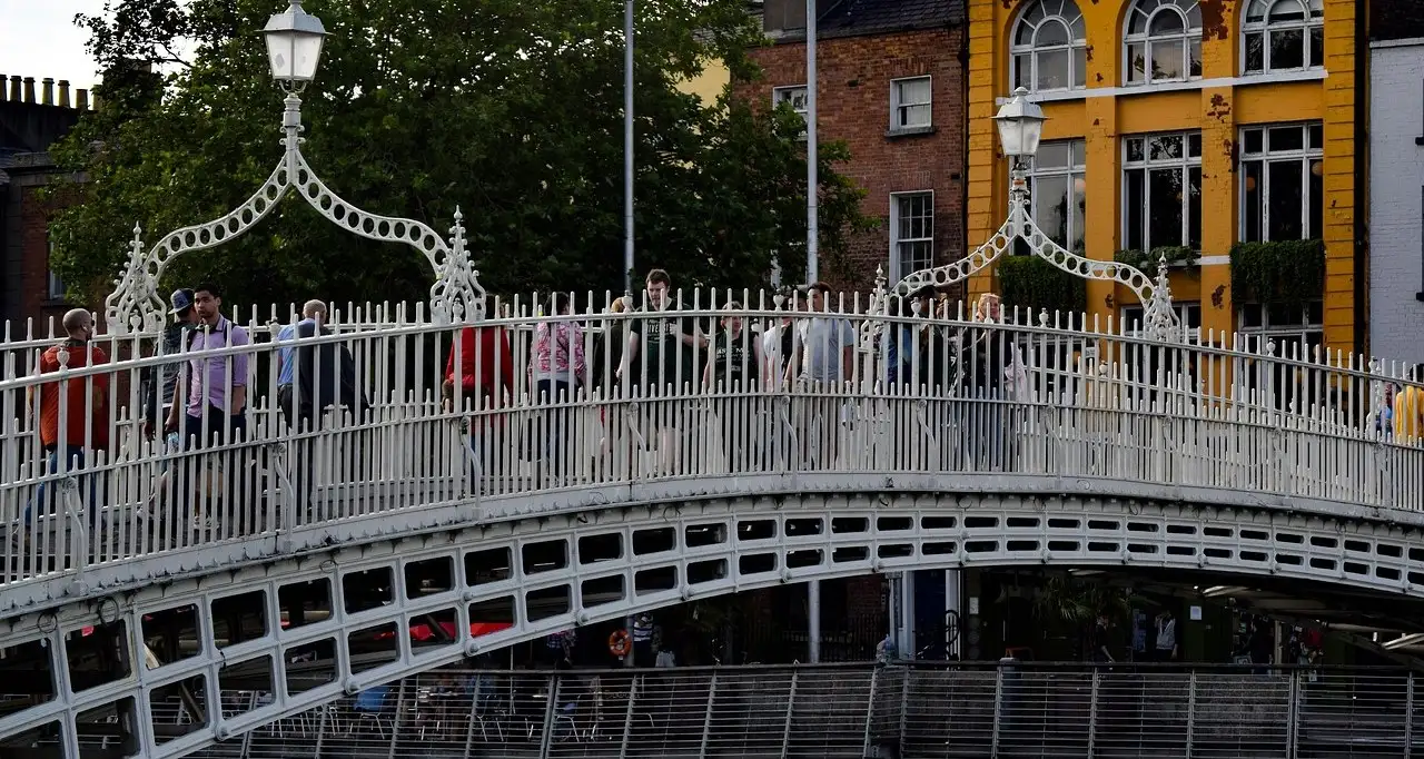 People crossing the Ha'penny Bridge over the Liffey, near Aston Quay