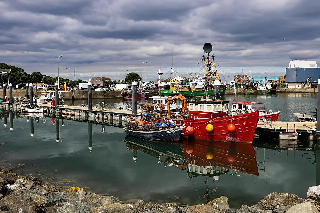 Fishing boats moored in Howth harbour under a grey sky