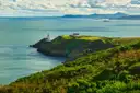 Howth Head with the Baily Lighthouse on a green point above Dublin Bay