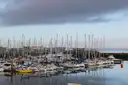 Sailing boats moored in Howth marina under a grey sky