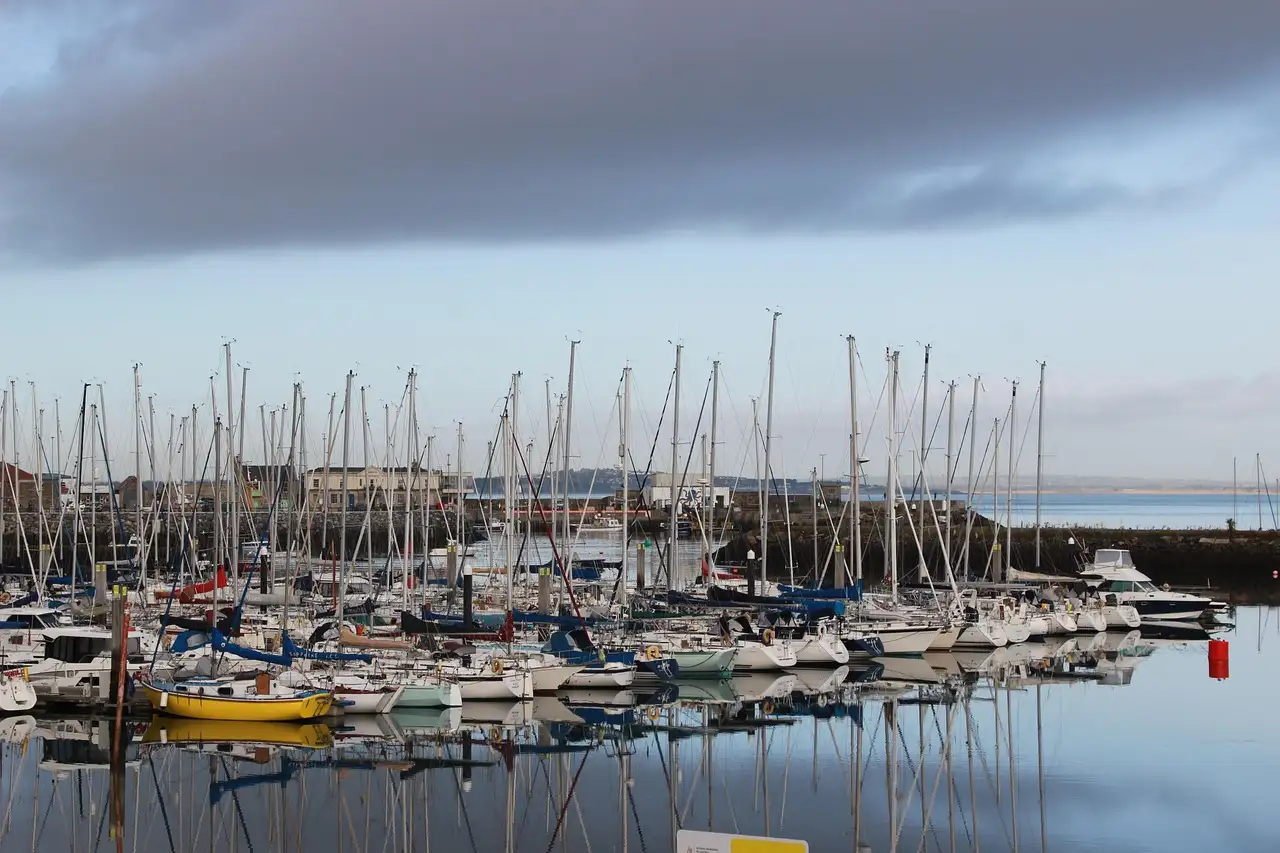 Sailing boats moored in Howth marina under a grey sky
