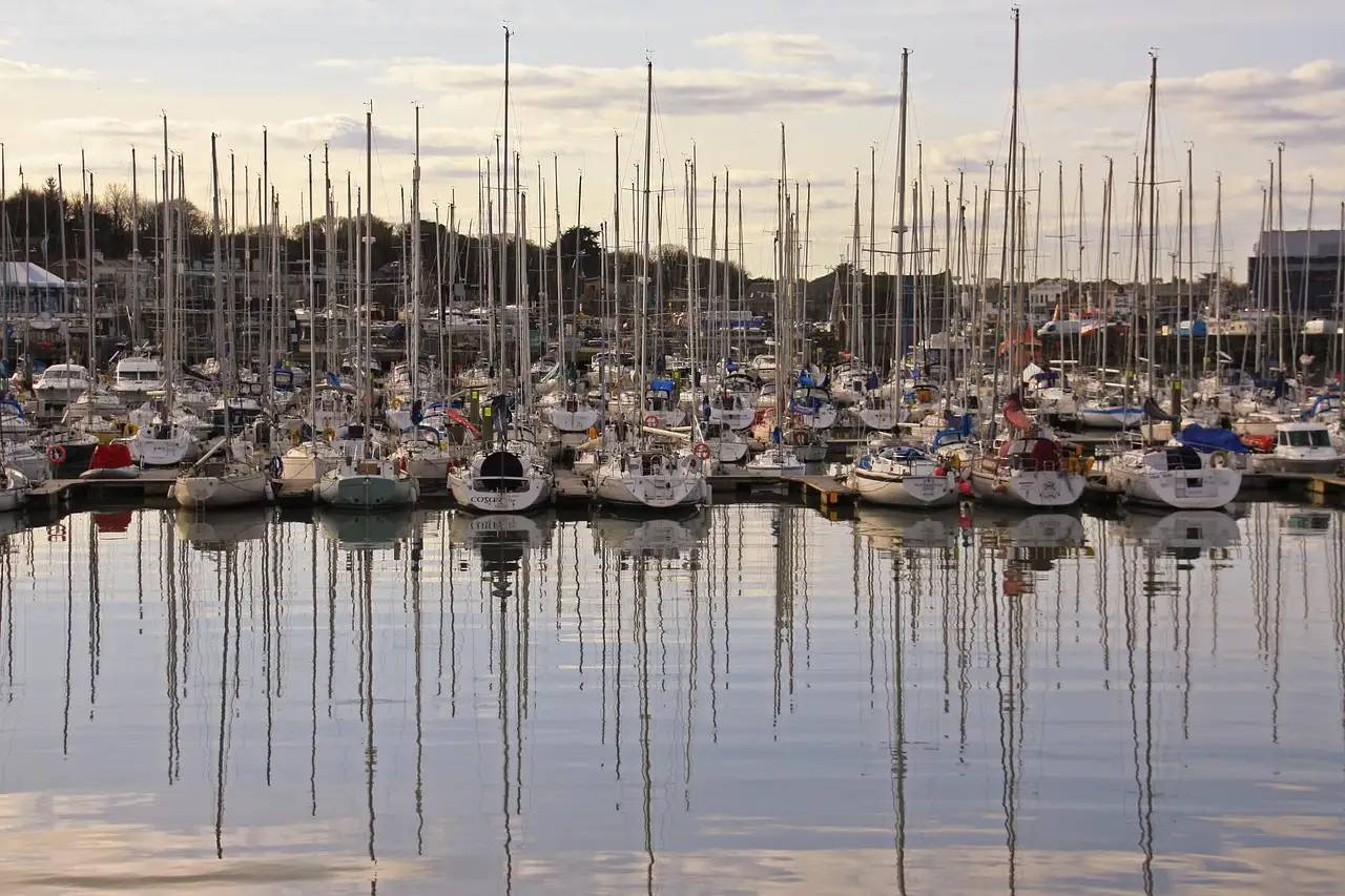 Sailing boats and their masts reflected in Howth marina