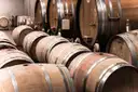 Wooden wine and whiskey barrels lined up in a cellar