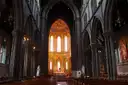 The nave of St Mary's Cathedral in Kilkenny, with stone arches and a lit altar