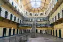 The Victorian east wing of Kilmainham Gaol, with iron staircases and cell doors under a glass roof