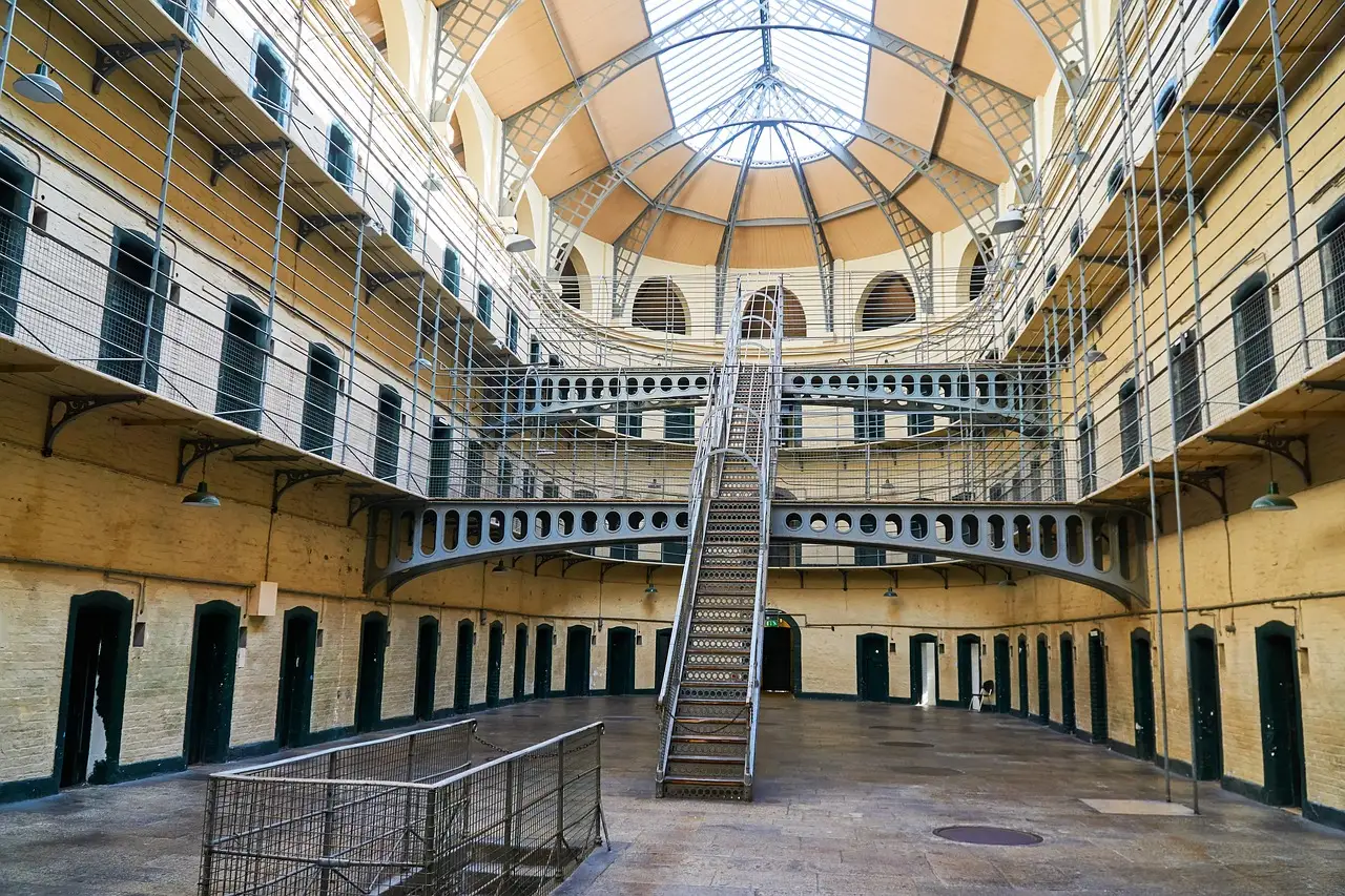 The Victorian east wing of Kilmainham Gaol, with iron staircases and cell doors under a glass roof