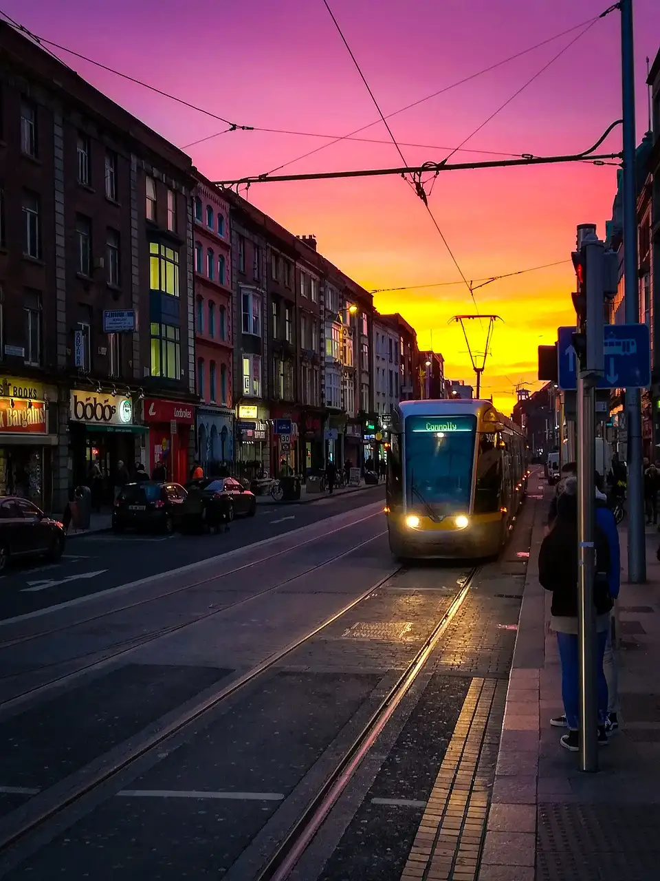 A Luas tram in a Dublin street at sunset