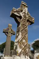 Two carved stone high crosses at Monasterboice against a blue sky