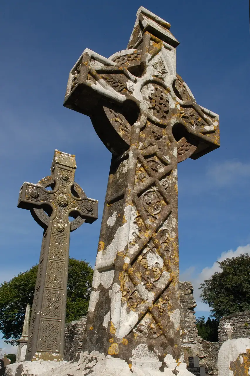 Two carved stone high crosses at Monasterboice against a blue sky