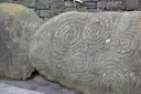 The large stone with carved spirals in front of the Newgrange entrance