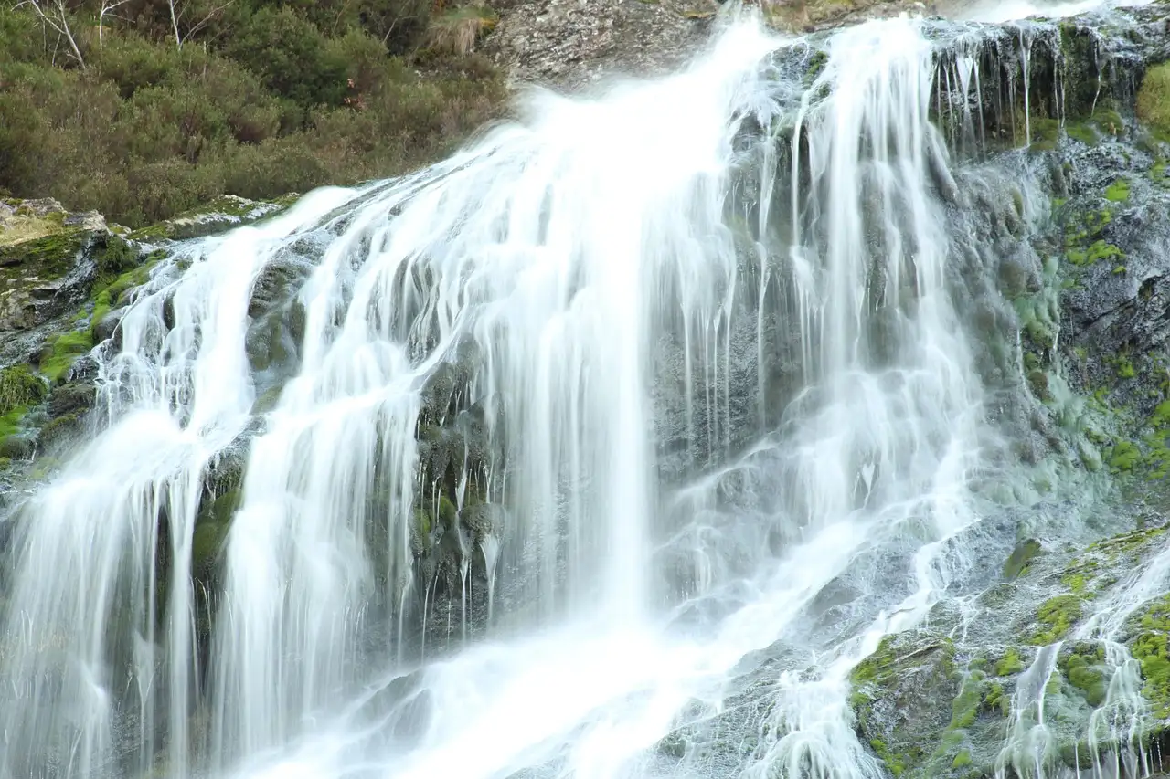 Powerscourt Waterfall spilling over a mossy rock face