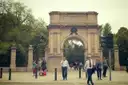 The stone Fusiliers' Arch at the entrance to St Stephen's Green in Dublin, with people walking past