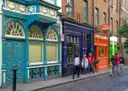Colourful painted shopfronts on a cobbled street in Dublin