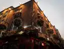 The upper floors of Temple Bar, hung with flower baskets and lit at dusk