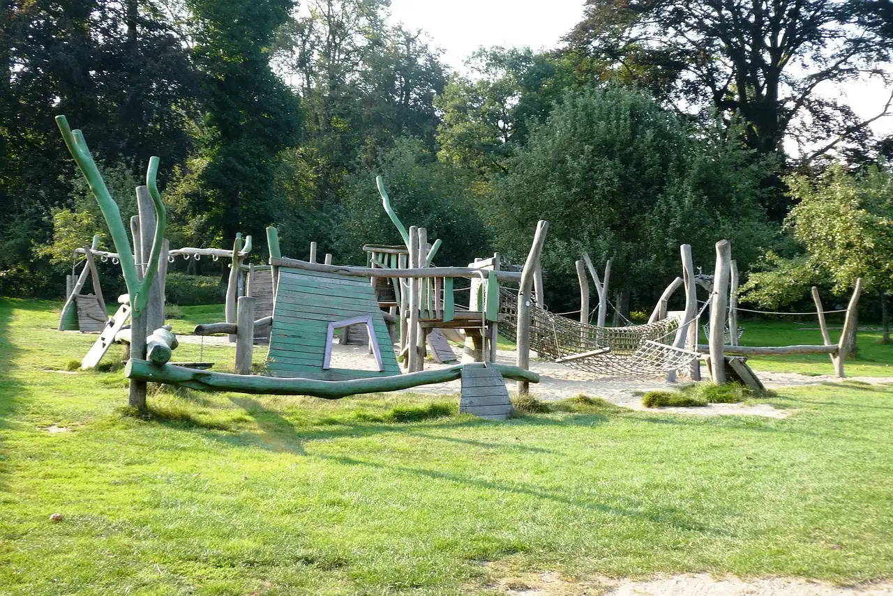 A wooden adventure playground on a lawn among trees (generic family-outing photo, not a named Dublin site)