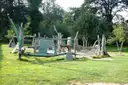 A wooden adventure playground on a lawn among trees (generic family-outing photo, not a named Dublin site)