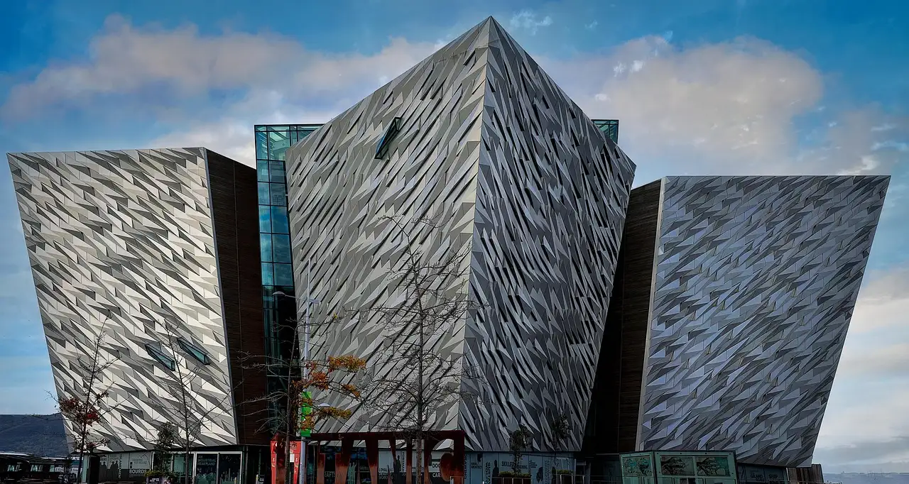 The angular, metal-clad Titanic Belfast building under a blue sky